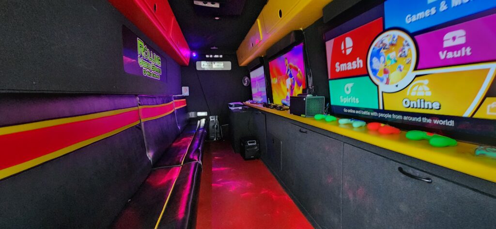 Rolling Video Games game van interior with gaming consoles and HD screens for residential driveway birthday parties in Connecticut
