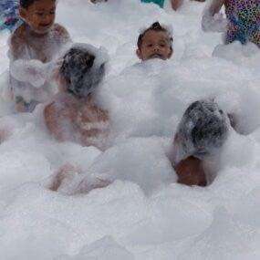 Kids enjoying the foam of bubbles