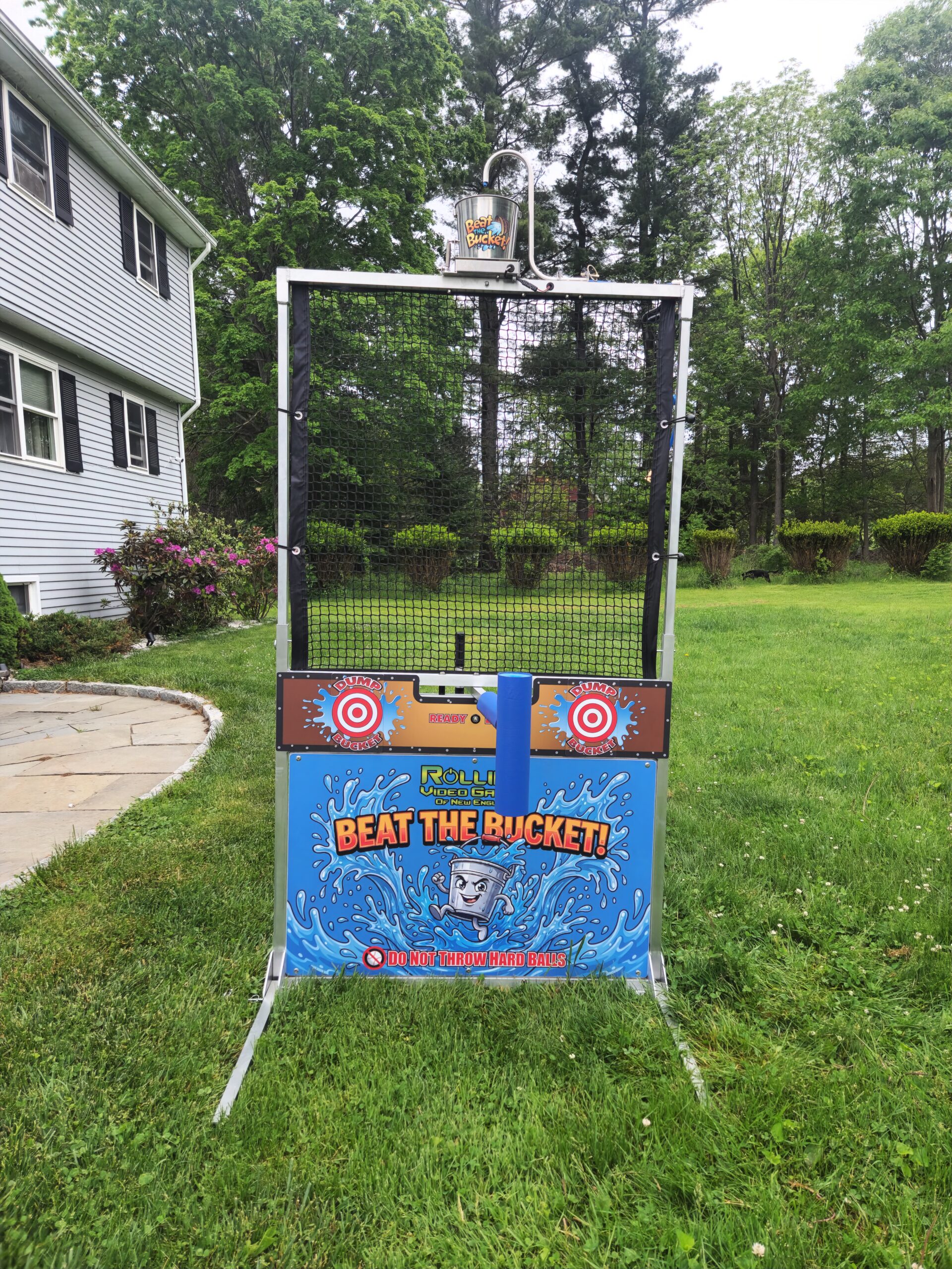 Interactive Beat The Bucket water game with blocking arm and water bucket overhead during outdoor party event