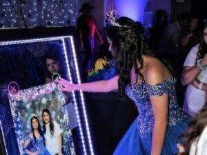 Girl dressed up for her Quinceañera posing in the photo booth at Rolling Video Games